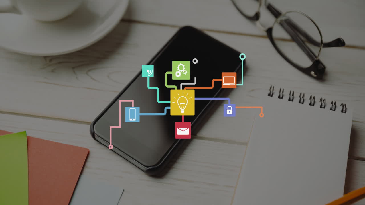 Animation of network of icons over smartphone on desk
