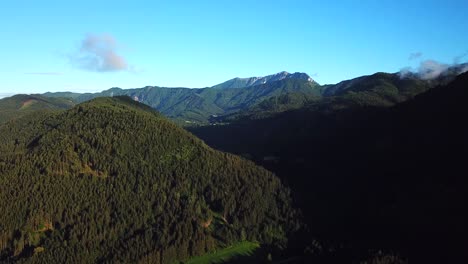 Aerial-view-above-mountain-ridges-near-Paternion,-Austria,-on-a-sunny-day