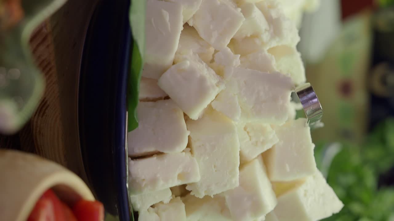 Close-up of cubed feta cheese in a serving bowl