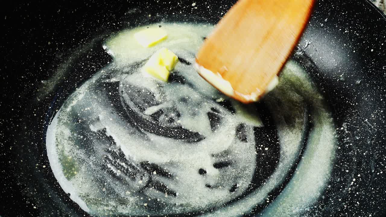 Butter on a frying pan with non-stick coating