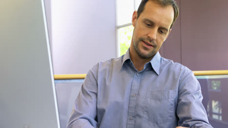 male executive working on computer at desk 4k