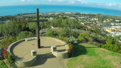 an aerial shot over a california christian cross over the city of ventura