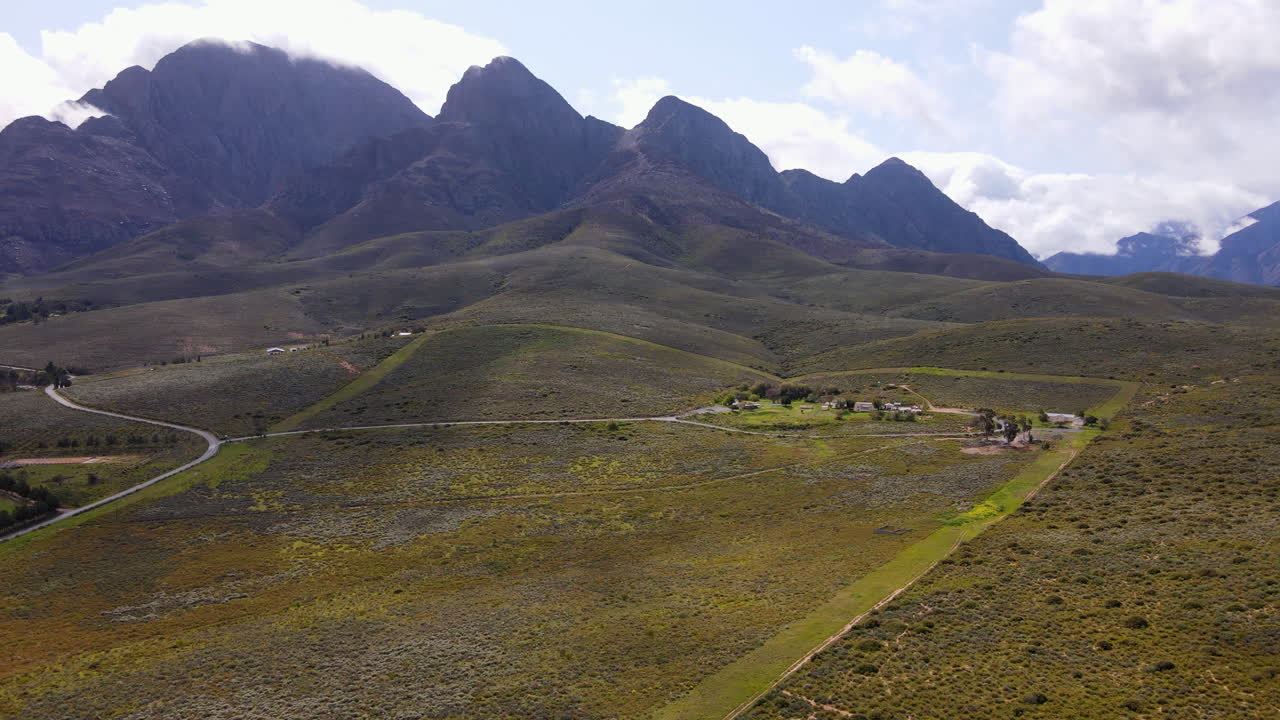 Aerial pullback view of semi-desert biome in Worcester reveals rugged mountains