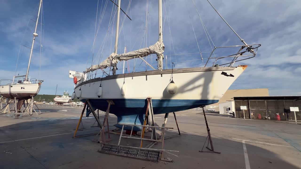 boat is standing on a stand in the harbor