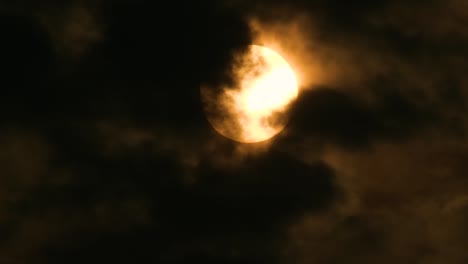 Gelber-Mond-Oder-Gelbe-Sonne,-Gesehen-Durch-Flecken-Dunkler-Wolken,-Die-Sich-Schnell-Im-Wind-Bewegen