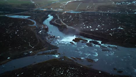 distant aerial over godafoss icelandic waterfall in winter