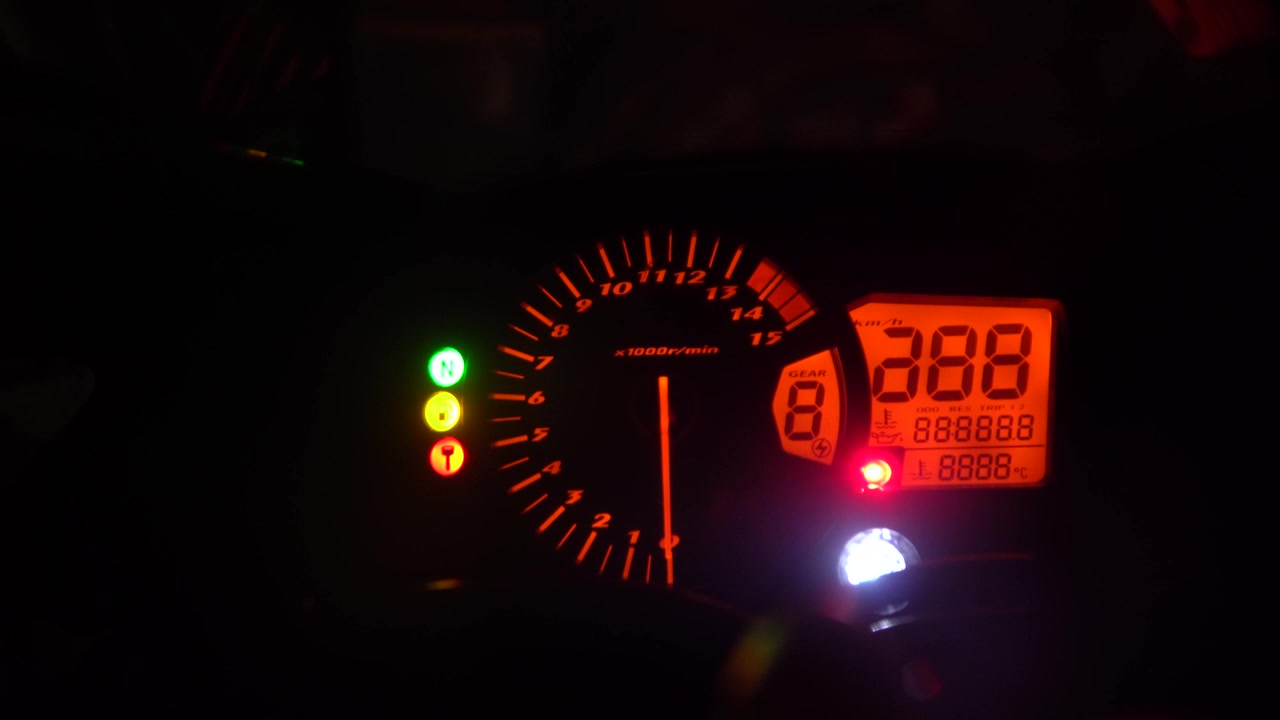 Tachometer in red light showing fast speed