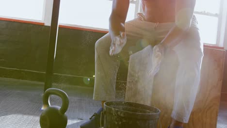 senior man clapping white powder on his hand before workout 4k