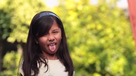 8 year old latina girl making funny face