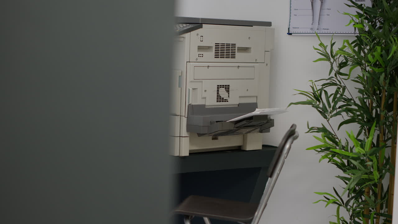 Office setup with computer, printer, and chair