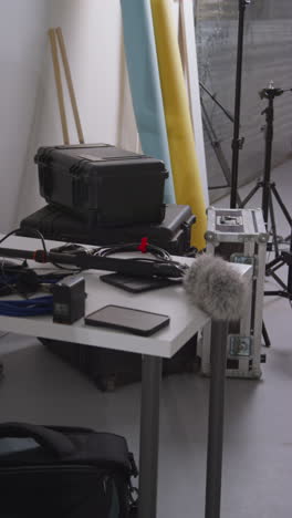 Vertical-Video-Of-Film-Sound-Recording-Equipment-With-Microphone-Boom-Pole-And-Wind-Muff-Shooting-Movie-In-Studio