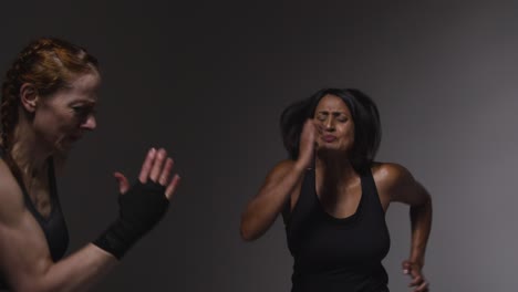 Studio-Shot-Of-Two-Mature-Women-Wearing-Gym-Fitness-Clothing-Doing-Cardio-Exercise-Running-On-The-Spot-Together-1