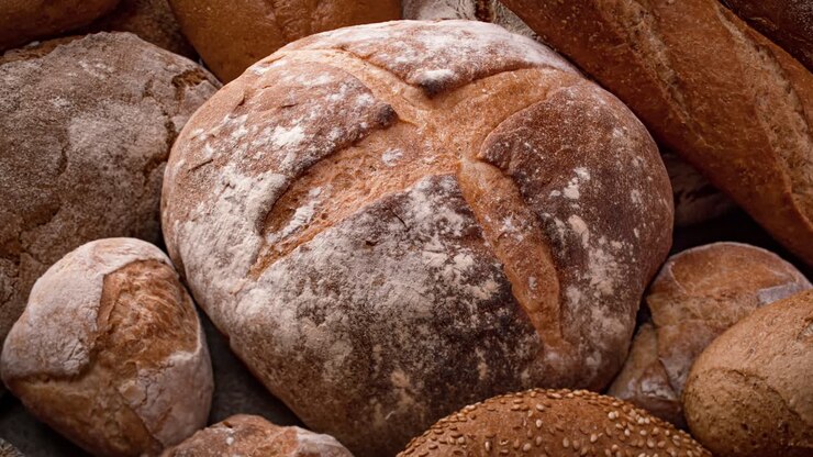 Freshly baked natural bread is on the kitchen table.