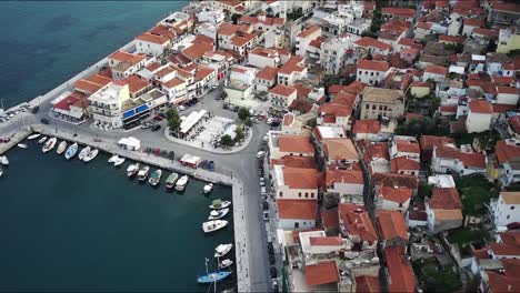 An-aerial-of-the-Gythio-town-in-Greece-with-small-houses-and-buildings-and-mountains-in-the-background