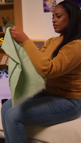 woman trying on a scarf at home