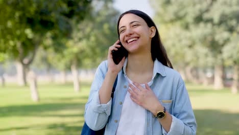 happy indian girl talking on a call