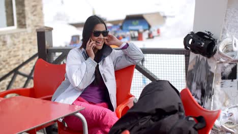 Young-woman-relaxing-at-an-alpine-ski-resort