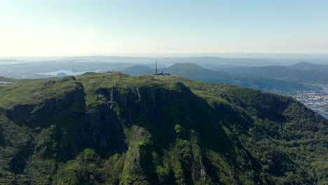 aerial footage approaching the summit of mount ulriken from the north, highlighting panoramic mountain scenery