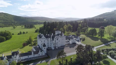 aerial pull back shot revealing blair castle on a sunny day