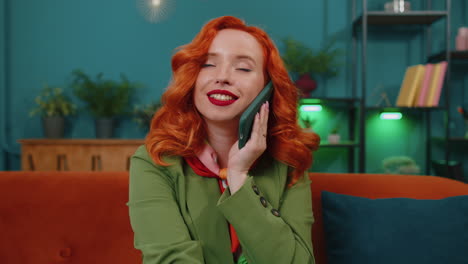 Red-hair-woman-enjoying-smartphone-call-talking,-mobile-phone-conversation-with-friends-at-home