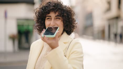 young woman smiling confident talking on the smartphone at street