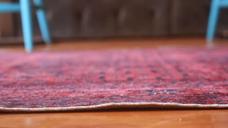 close-up of a red vintage rug on a wooden floor