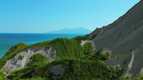 coastal landscape with lush vegetation and volcanic hills