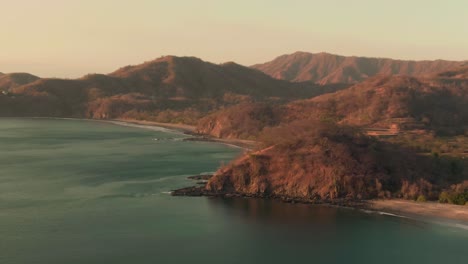 Aerial-parallax-motion-shot-of-Flamingo-beach-in-warm-sunset