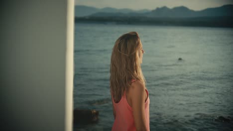 Woman-standing-in-front-of-the-sea-and-attending-around