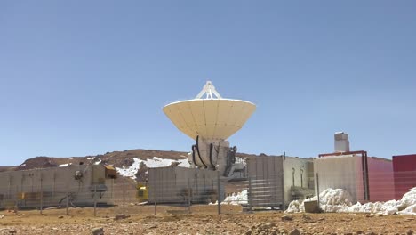 A-shot-of-the-site-of-a-telescope-of-the-Alma-observatory,-containers-standing-next-to-it
