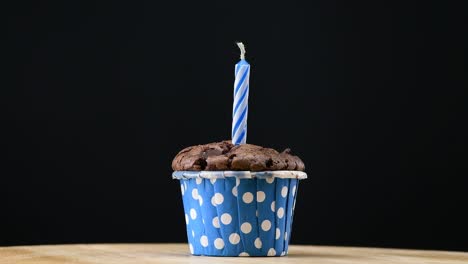 cupcake party with candle on blue background cinemagraph seamless loop.