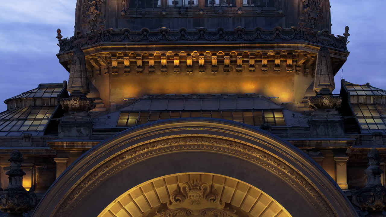 Aerial drone view of the illuminated Palace of the Deposits and Consignments in the evening. Blue hour in Bucharest, Romania
