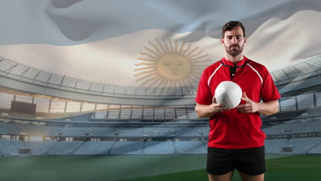 professional rugby player standing in front of a flag and stadium