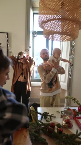 family celebrating christmas with a baby