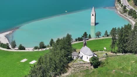 historic church tower emerging from lake reschen in south tyrol