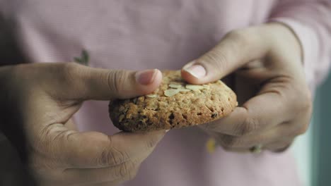 person holding an oatmeal cookie