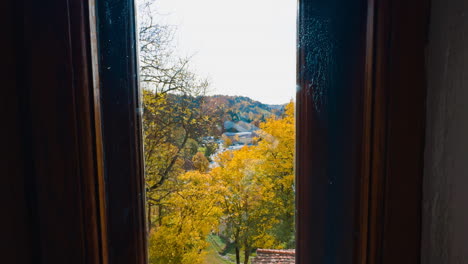 autumn nature through the old window in the building. cramped room in the bran castle, romania.
