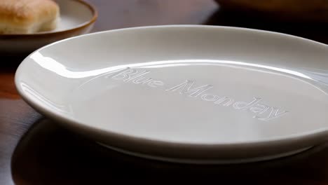 empty white plate with 'blue monday' inscription