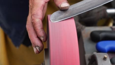 close up of a grinding wheel sharpening a knife