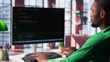 vertical video male programmer types code on computer and running script
