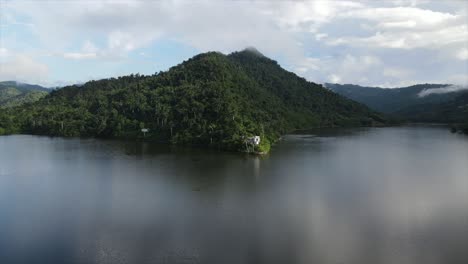 hilly forested coast of lake under clouds