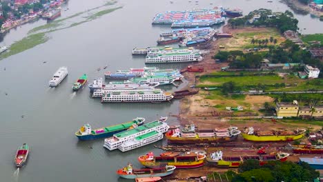 bangladeshi shipyard with boat construction and docked colorful boats