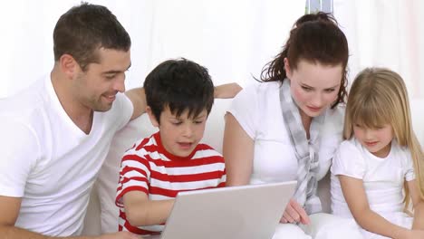 happy family at home looking at a computer