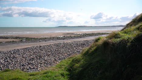 Bright rocky Port Beach in Ireland on a clear day -wide