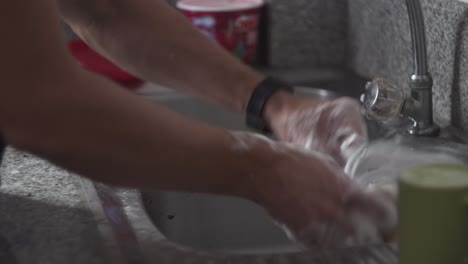 worker cleaning blender with soap and water - medium shot