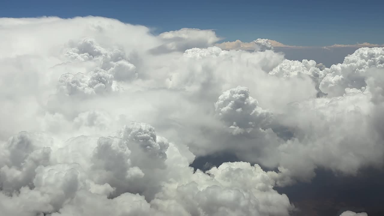 An immersive pilot’s POV FPV view while flying through stormy skies full of cottony cumulus storm clouds at high altitude cruise. Utra-realistic aerial shot, 4K