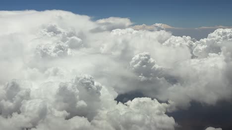 an immersive pilot’s pov fpv view while flying through stormy skies full of cottony cumulus storm clouds at high altitude cruise. utra-realistic aerial shot, 4k