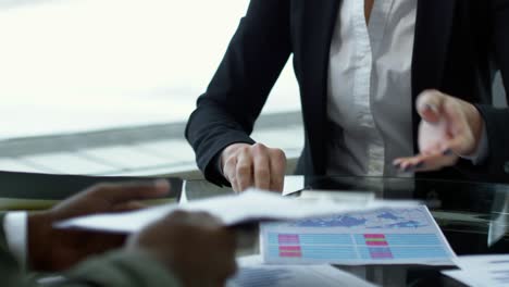 businesswoman signing contract and shaking hands with partner