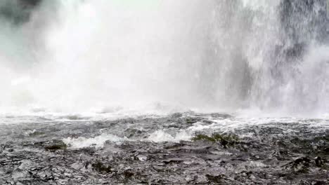 water gushes into pool below linville falls waterfall near boone nc, north carolina