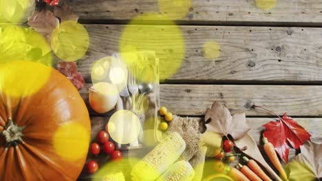 animation of halloween pumpkin and autumn produce on wooden background